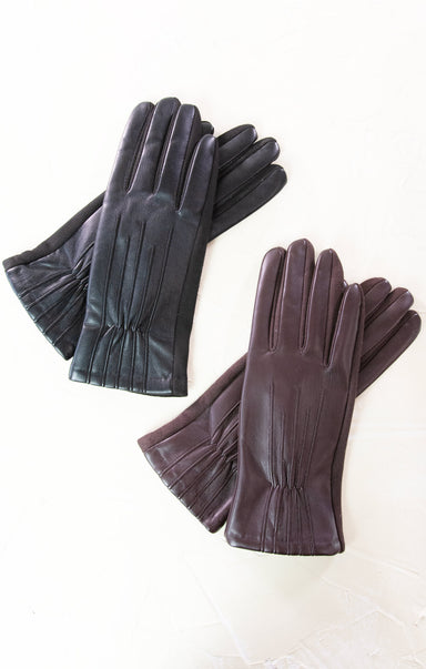 Pair of dark gray leather gloves on a white background
