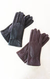 Pair of dark gray leather gloves on a white background