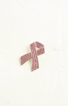 Pink ribbon brooch with crystals on a white background