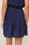 Navy blue skirt worn by a person on a beige background