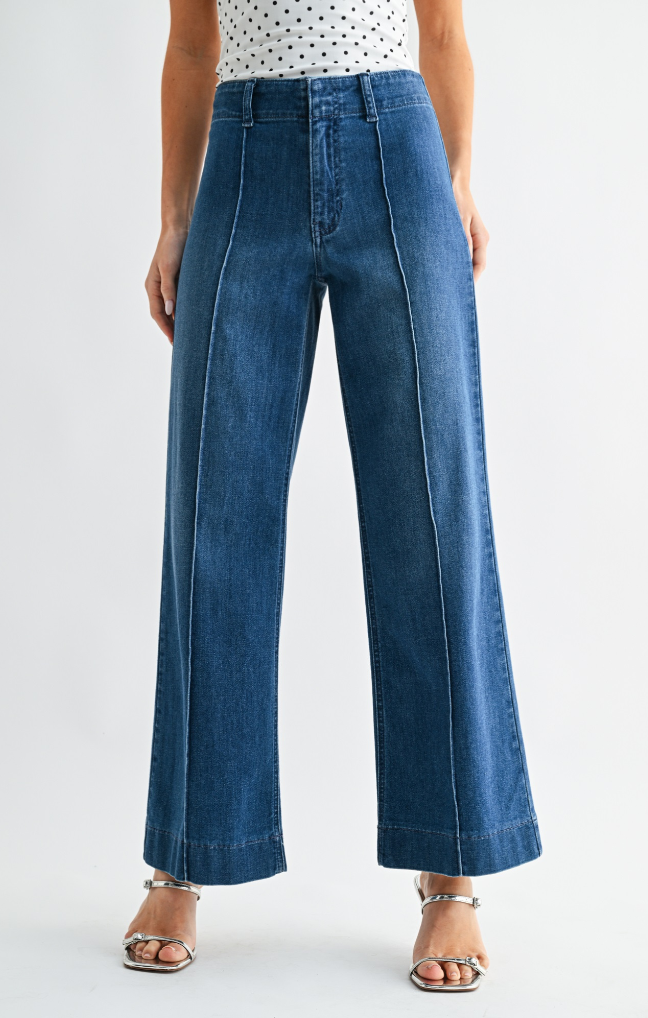 Person wearing blue jeans on a white background