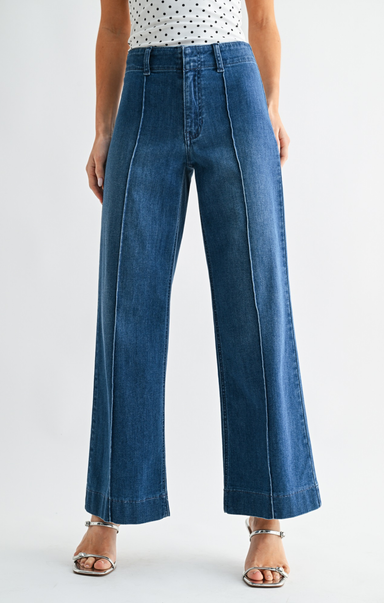 Person wearing blue jeans on a white background