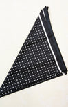 Black fabric with white polka dots and a white border on a white background