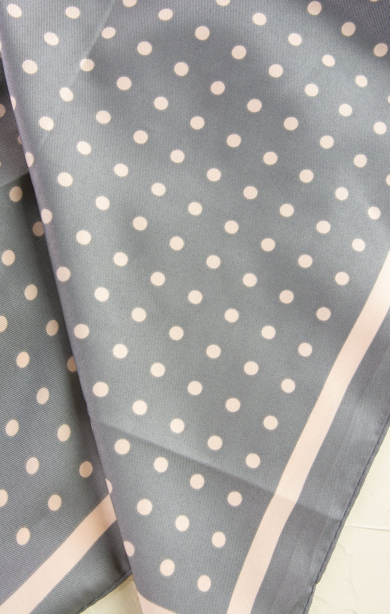 Gray fabric with white polka dots on a light background