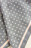 Gray fabric with white polka dots on a light background