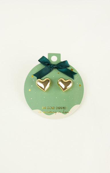 Heart-shaped gold earrings on a green card with a bow