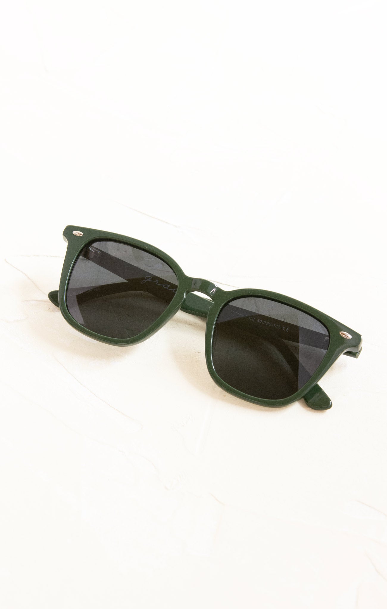 Green sunglasses on a white background