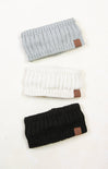 Three knitted headbands in gray, white, and black with brown leather patches on a white background.