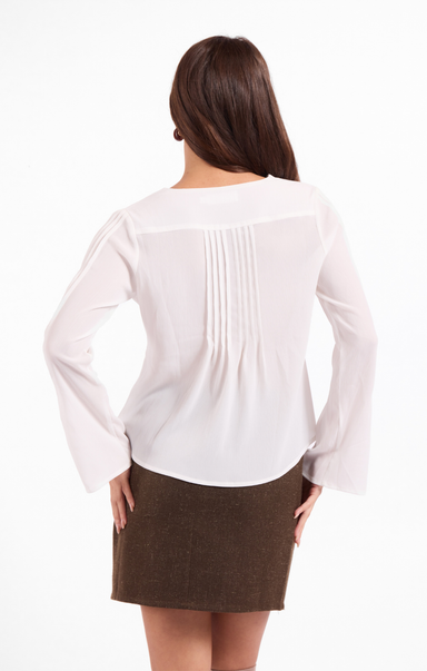 Woman wearing a white blouse and brown skirt on a white background
