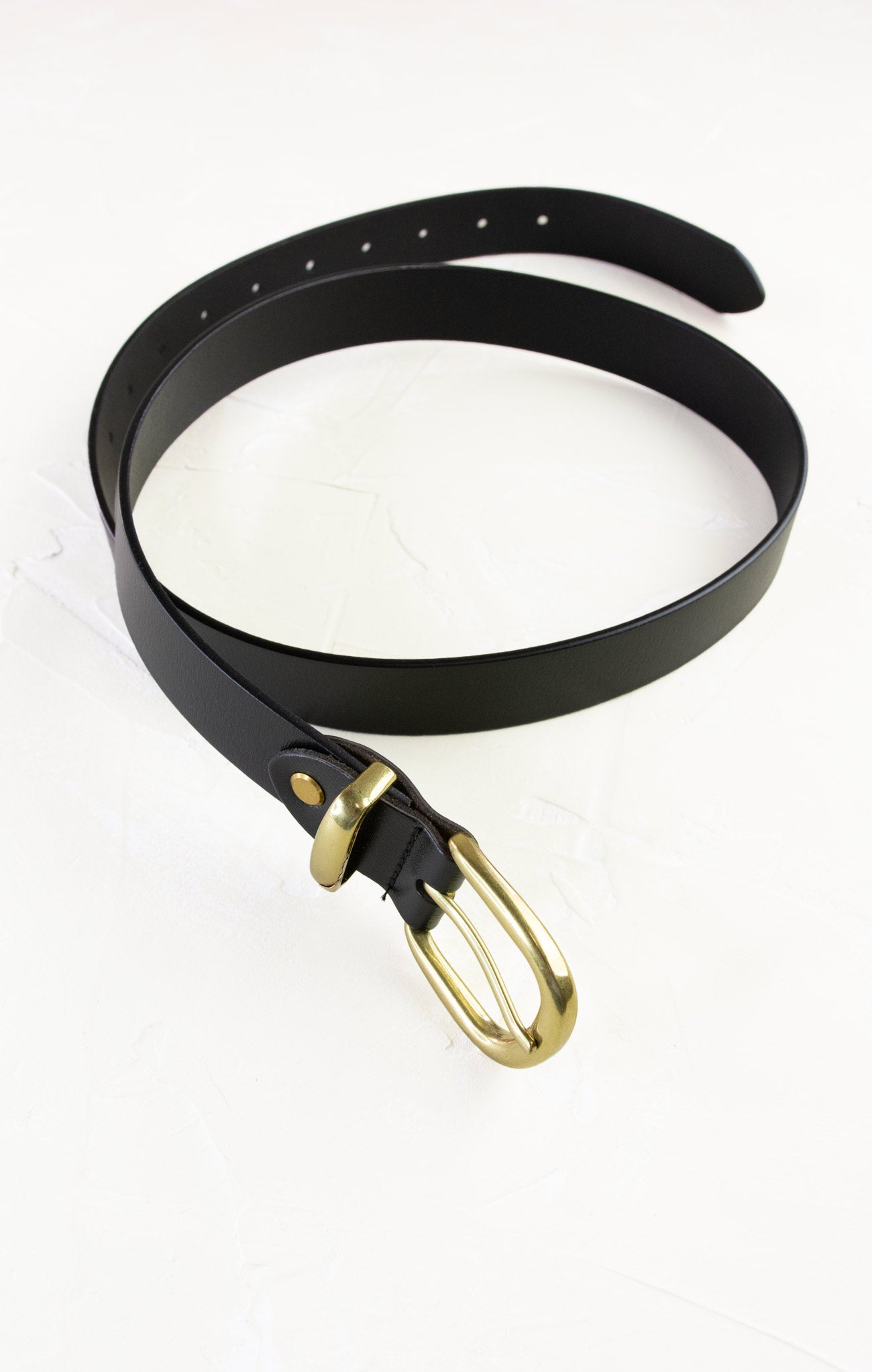 Black belt with a gold buckle on a white background