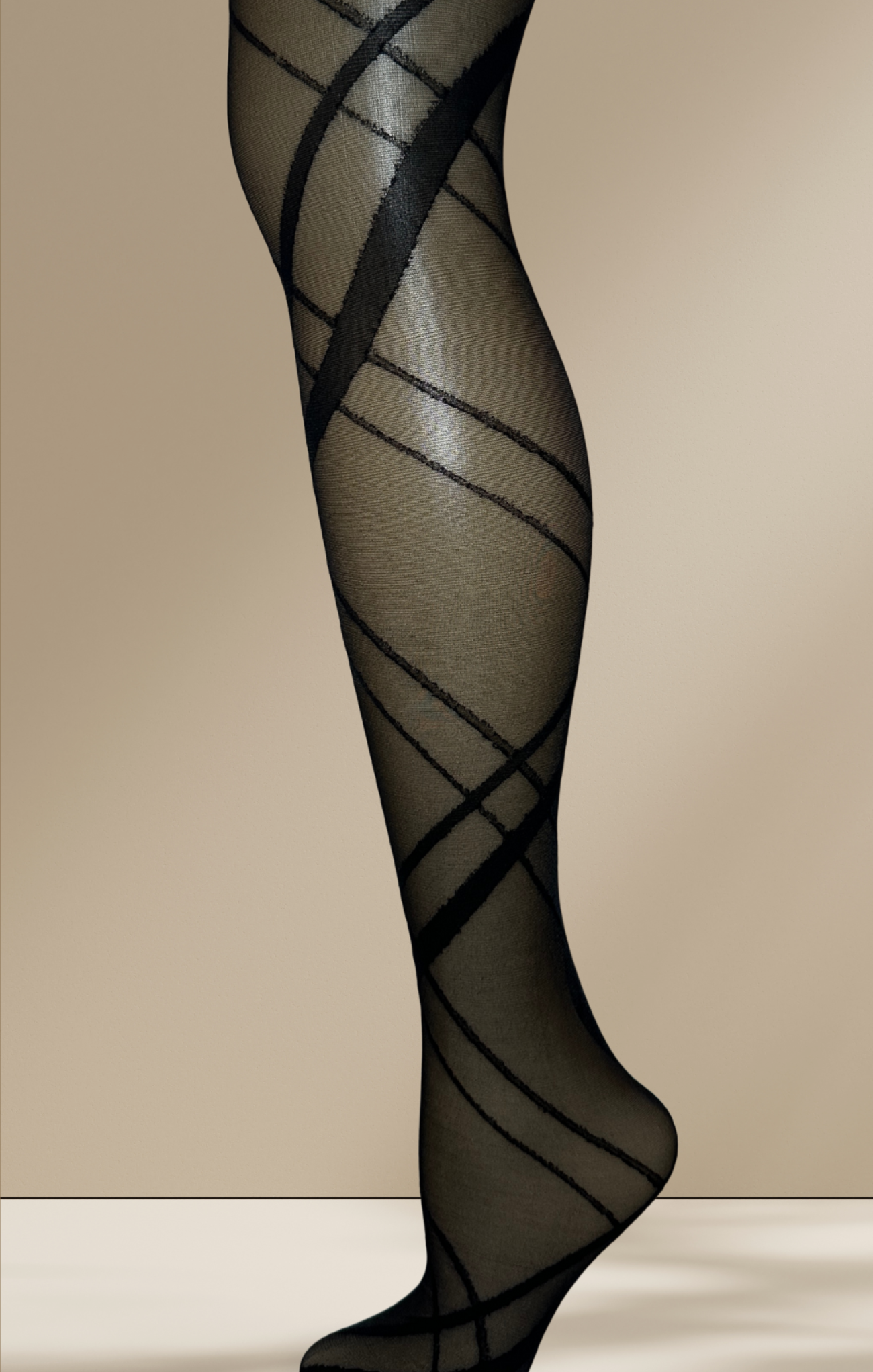 Black patterned sheer stockings on a beige background