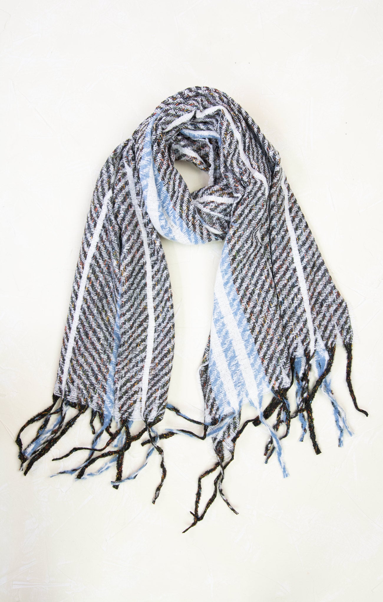 Striped scarf with black, white, and blue pattern on a white background
