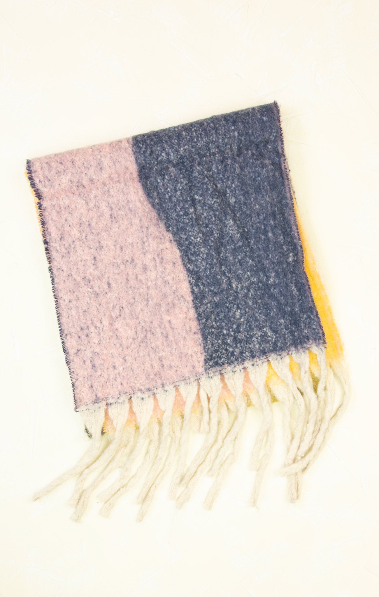 Two-tone scarf with pink and blue hues and fringes on a white background