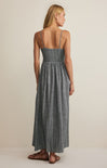 Woman wearing a gray striped dress on a beige background