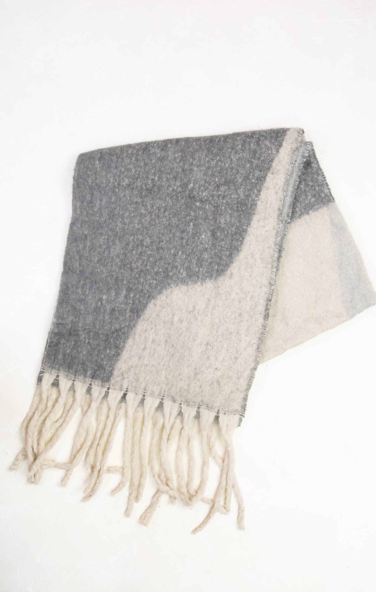 Gray and white checkered blanket with fringes on a white background