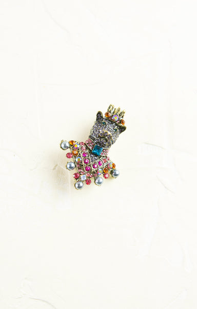 Decorative brooch with colorful gemstones on a white background