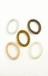Set of five hair ties in beige, brown, and white on a white background
