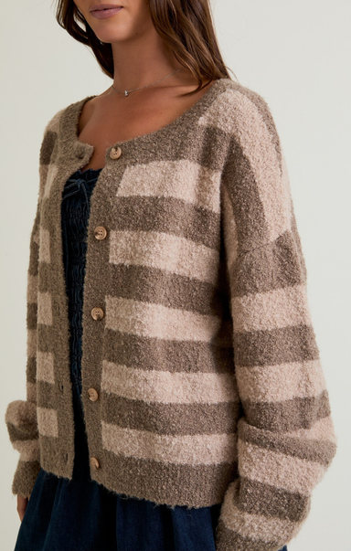 Plaid cardigan worn by a person on a plain background