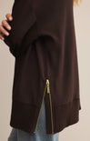 Brown jacket with a gold zipper on a neutral background