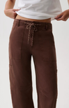 A person wearing brown wide-leg cargo pants with a drawstring waist, shown from the waist down against a plain light background.