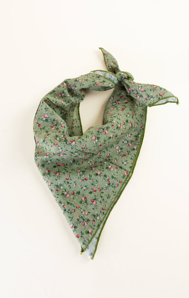 Green floral patterned scarf on a white background