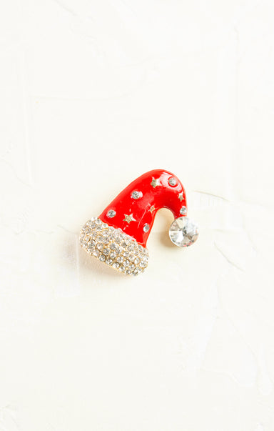 Red Santa hat ornament with rhinestones on a white background