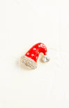 Red Santa hat ornament with rhinestones on a white background