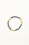 Bracelet with blue beads and gold accents on a white background