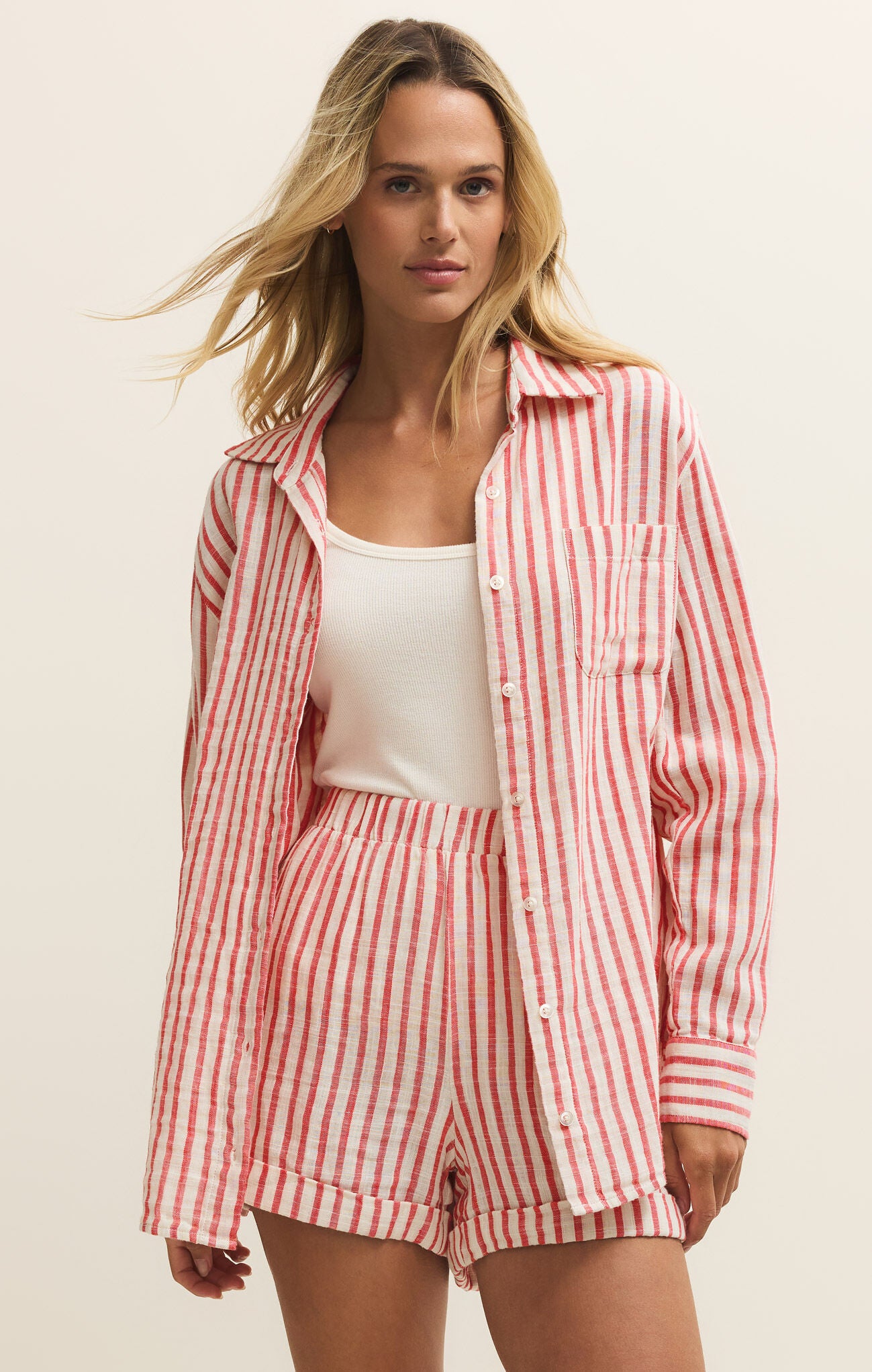 Woman wearing a red and white checkered outfit on a beige background