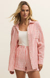 Woman wearing a red and white checkered outfit on a beige background