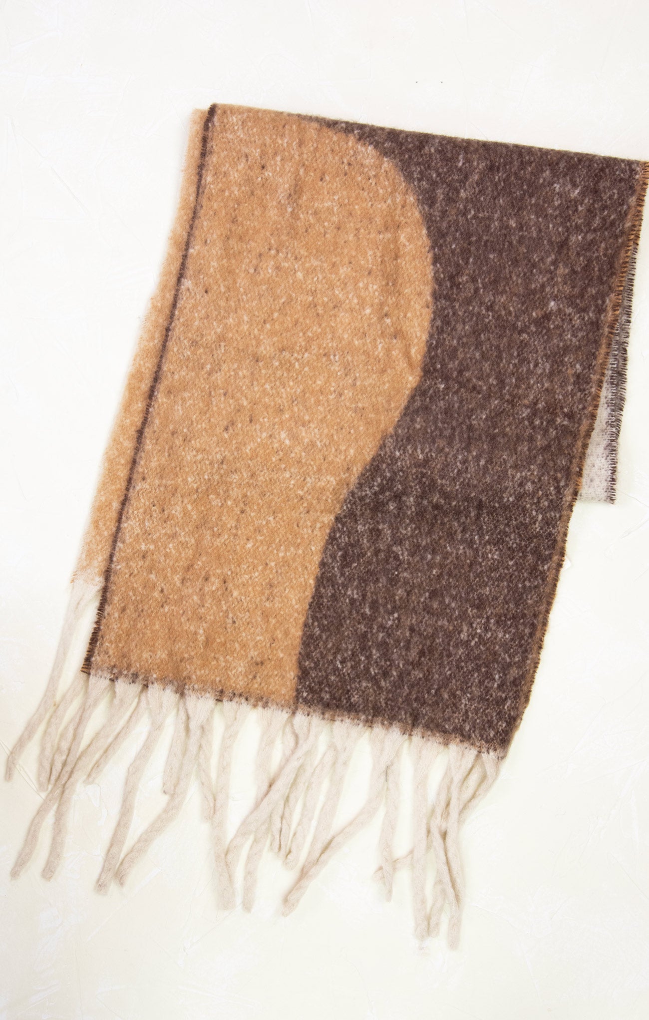 Two-tone brown scarf with fringes on a white background
