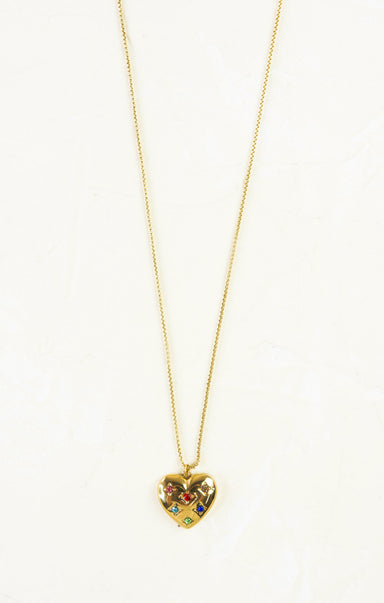 Gold heart-shaped necklace with colorful stones on a white background