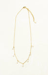 Gold necklace with small beads on a white background