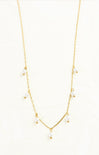 Gold necklace with small pearls on a white background