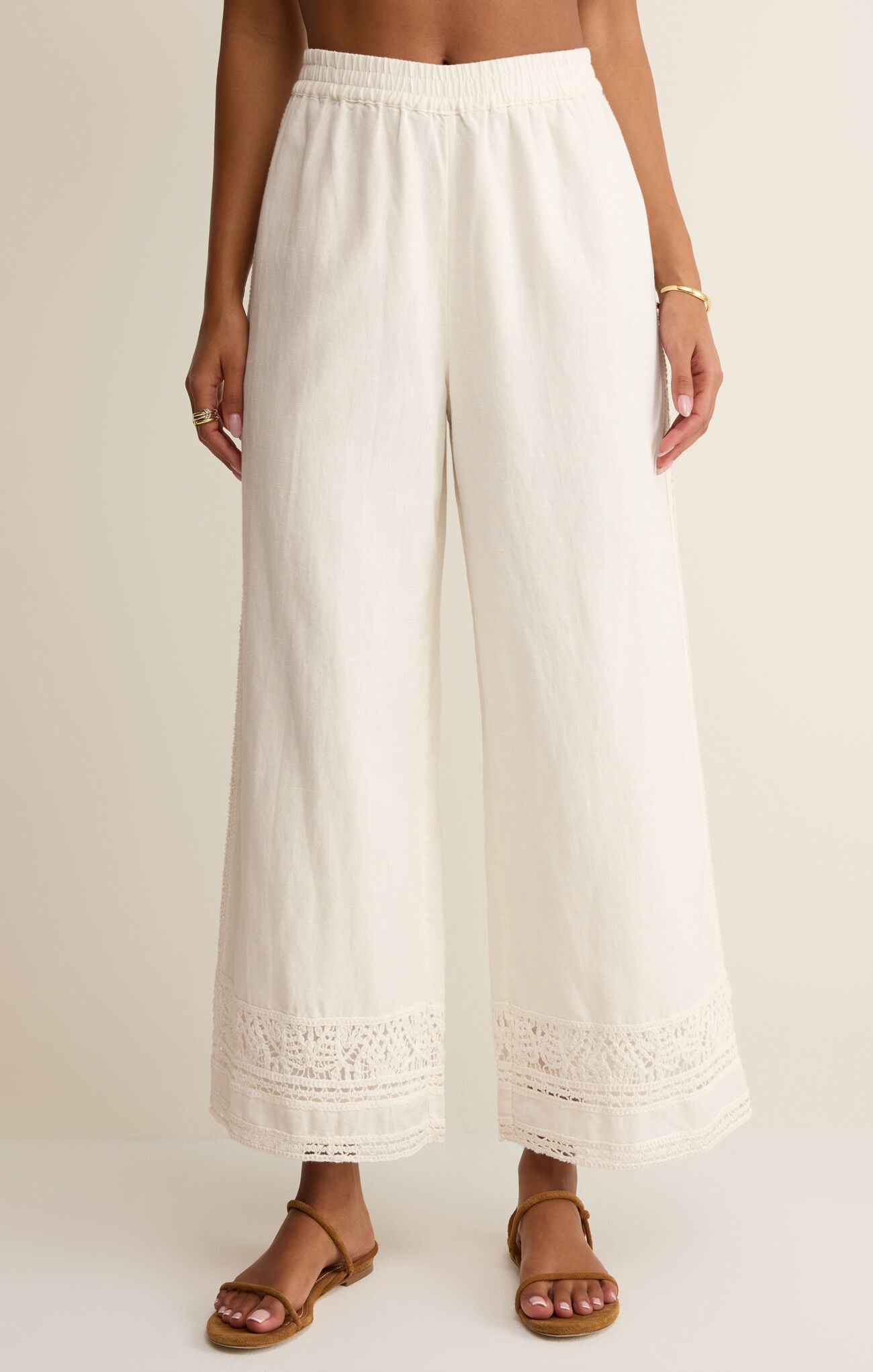 White wide-leg pants worn by a person on a plain background