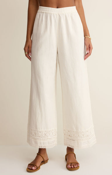 White wide-leg pants worn by a person on a plain background