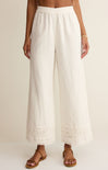 White wide-leg pants worn by a person on a plain background