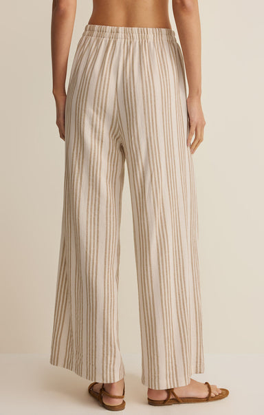 Striped pants worn by a person on a beige background