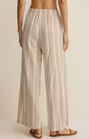 Striped pants worn by a person on a beige background