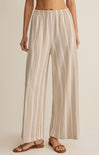 Striped pants worn by a person on a beige background