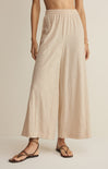 Beige wide-leg pants worn by a person on a plain background