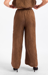 Brown pants worn by a person on a white background