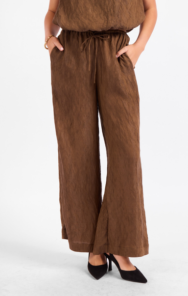 Brown wide-leg pants worn by a person on a white background