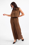 Woman wearing a brown sleeveless top and wide-leg pants on a white background