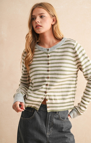 Woman wearing a striped sweater with a beige background