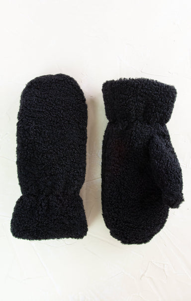 Pair of black fuzzy mittens on a white background