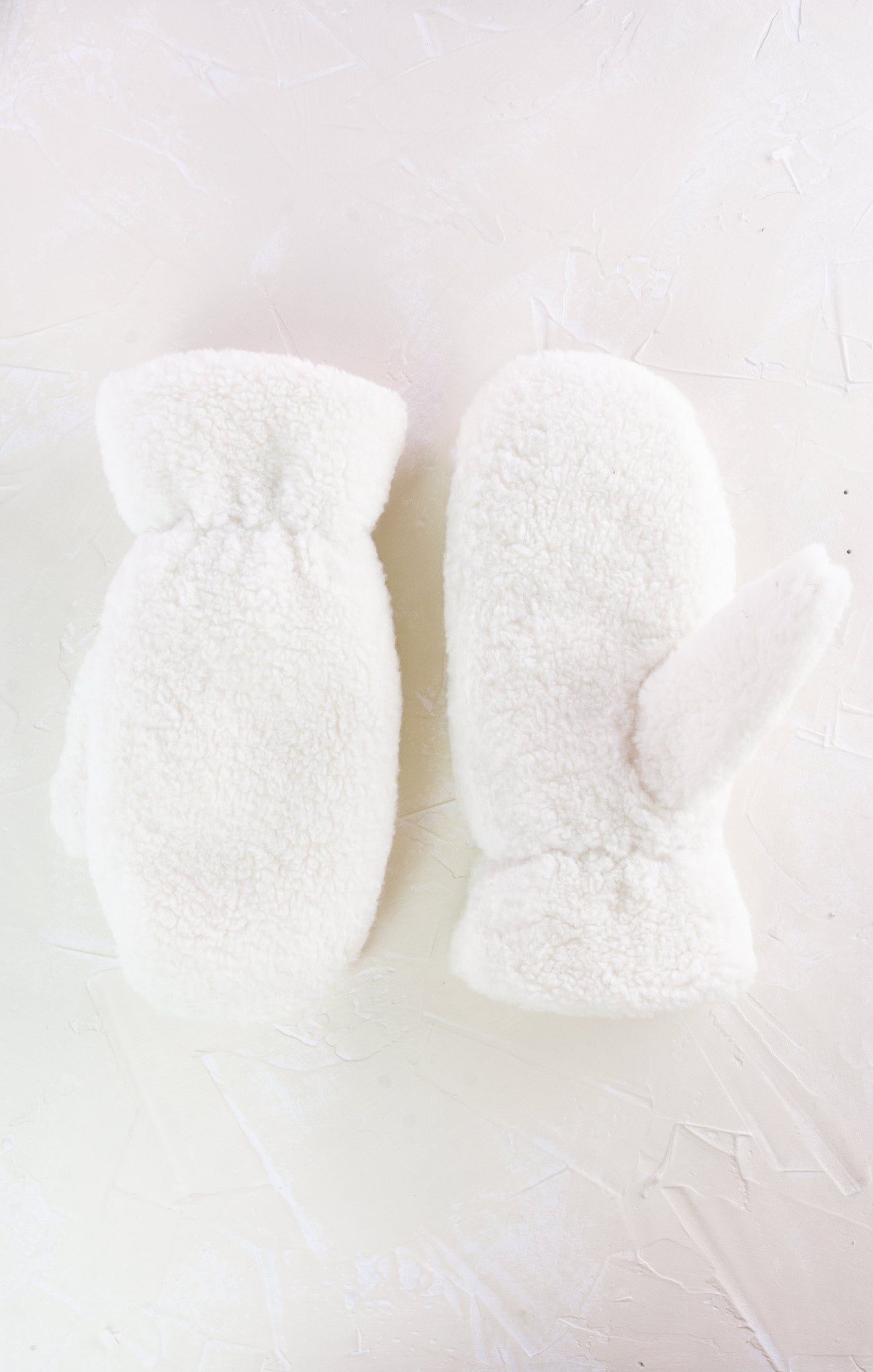 White fuzzy socks on a light gray background