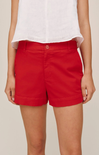 Red shorts worn by a person on a plain background