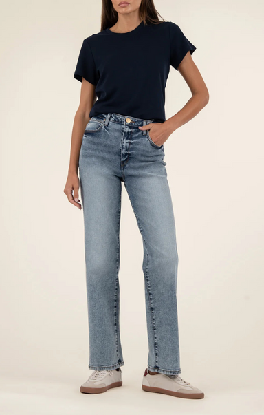 Person wearing a black t-shirt and light blue jeans on a plain background