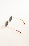 Sunglasses with gold frame and tortoiseshell accents on a white background